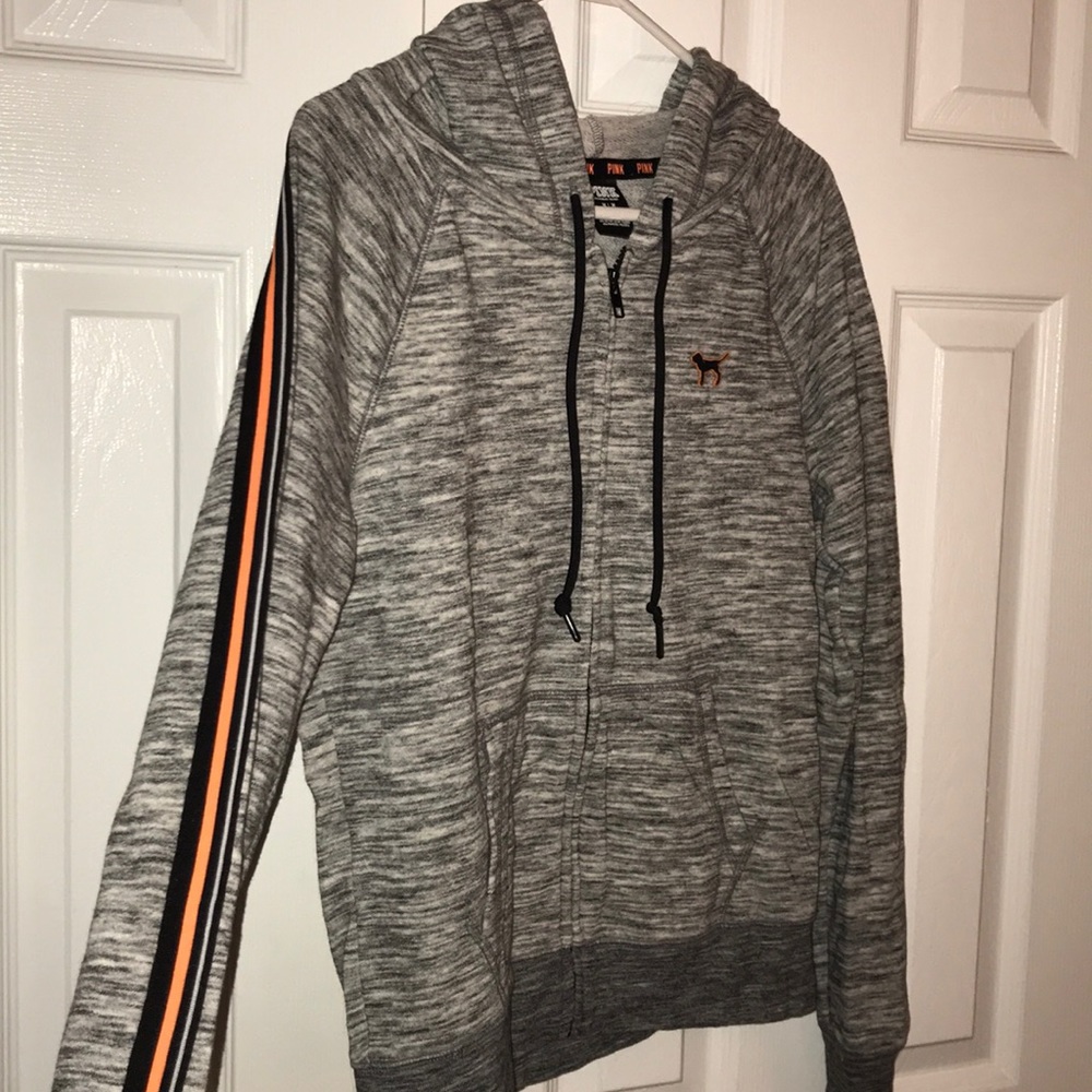 A grey zip up hoodie with orange & black detail!